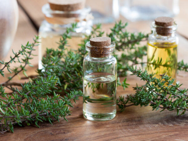 A bottle of oil sitting on top of a wooden table.