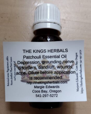 A bottle of patchouli essential oil on the back of a card.